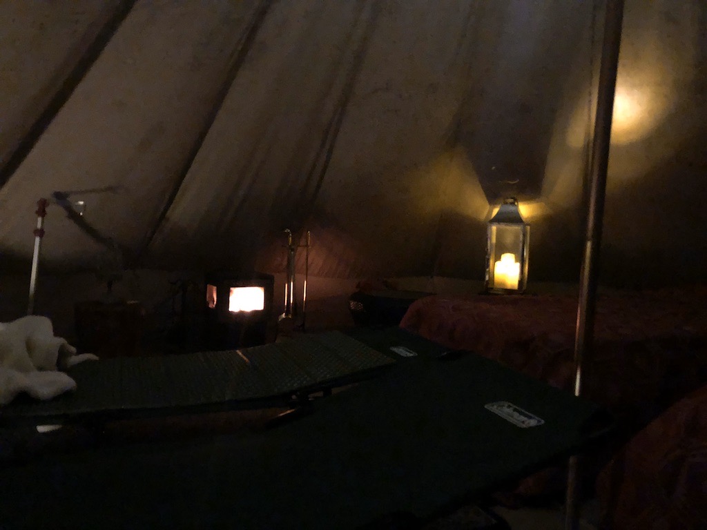 Interior of the author's older Feriendorf tent at night in 2019